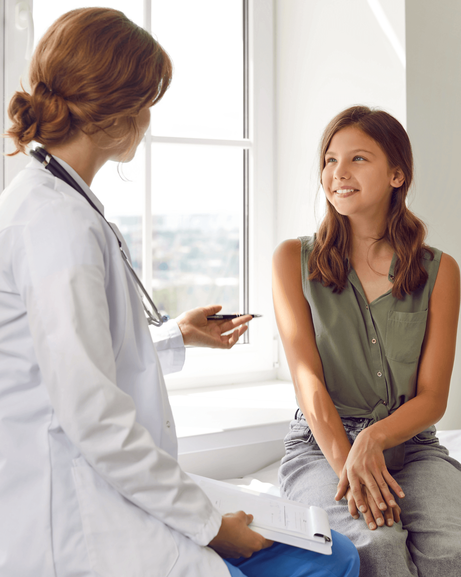 a smiling female doctor is holding a stethoscope in her hand .
